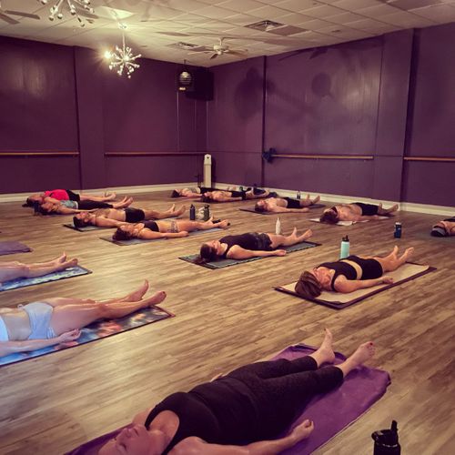 yoga students lying on their backs on their mats